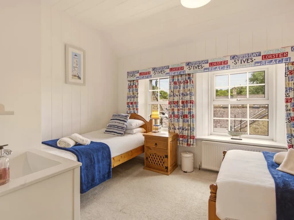 Comfortable twin bedroom with garden views and charming nautical accents