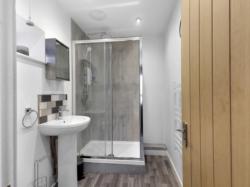 Modern bathroom with walk-in shower and wood-effect flooring