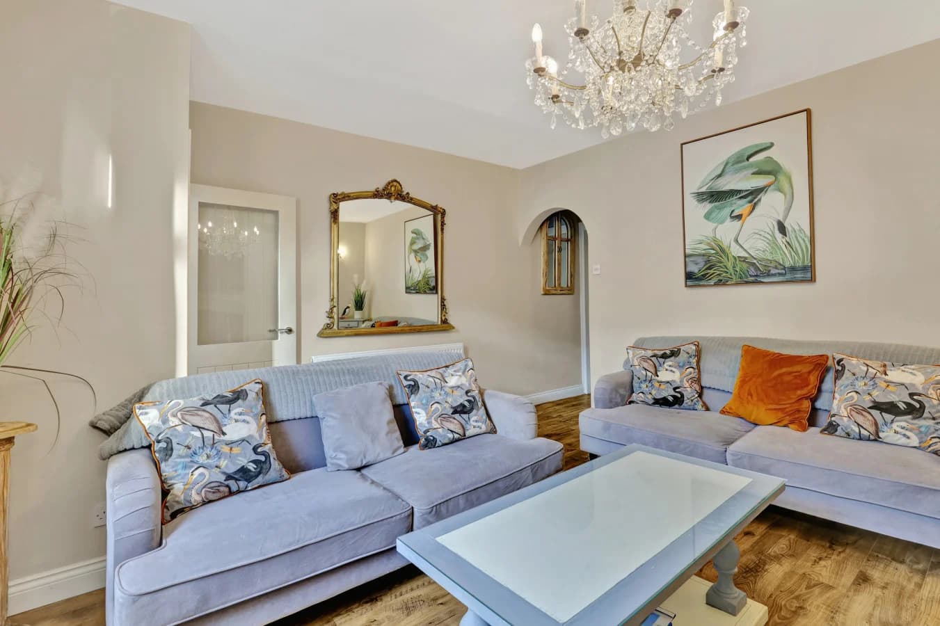 Elegant lounge with crystal chandelier and plush corner sofa