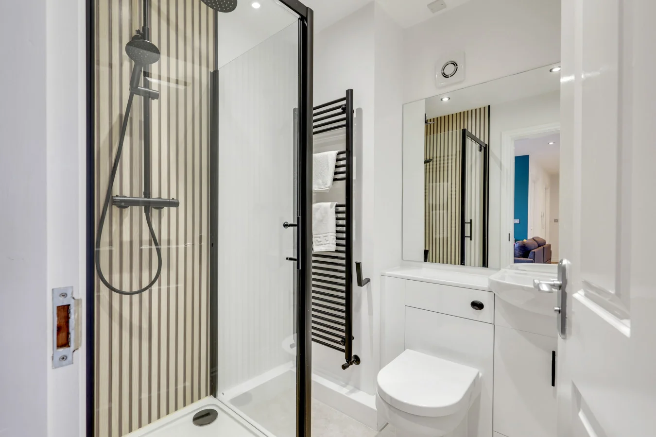 Modern shower room with black fixtures and vertical striped detailing