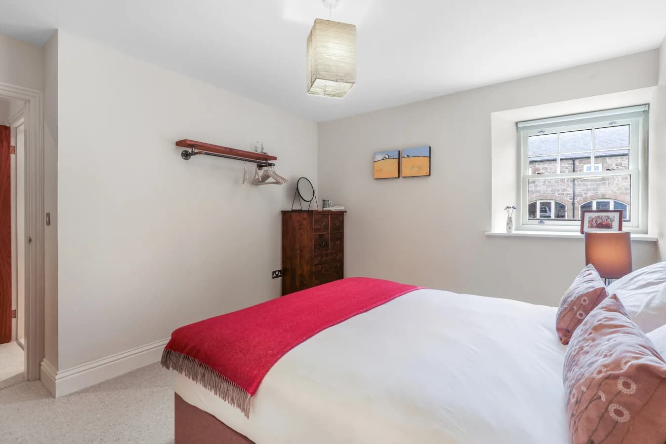 Bright king bedroom with countryside views and soft furnishings