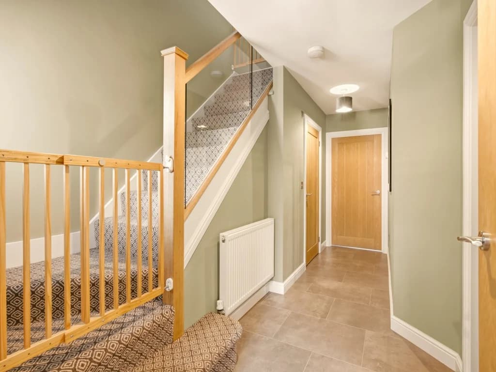 Welcoming hallway with staircase leading to the first-floor bedrooms