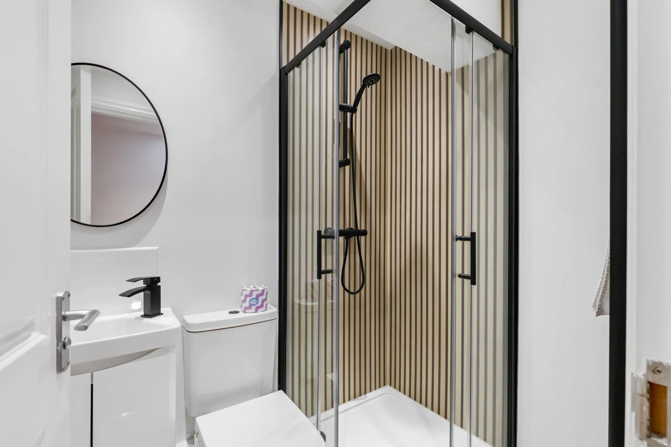 Modern shower room with walk-in enclosure and heated towel rail