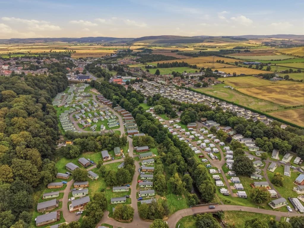 Aerial view of Riverside Holiday Park surrounded by open countryside
