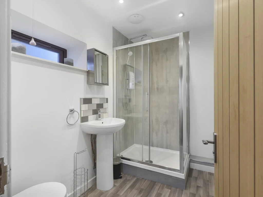 Contemporary shower room with timber-effect finishes and walk-in shower
