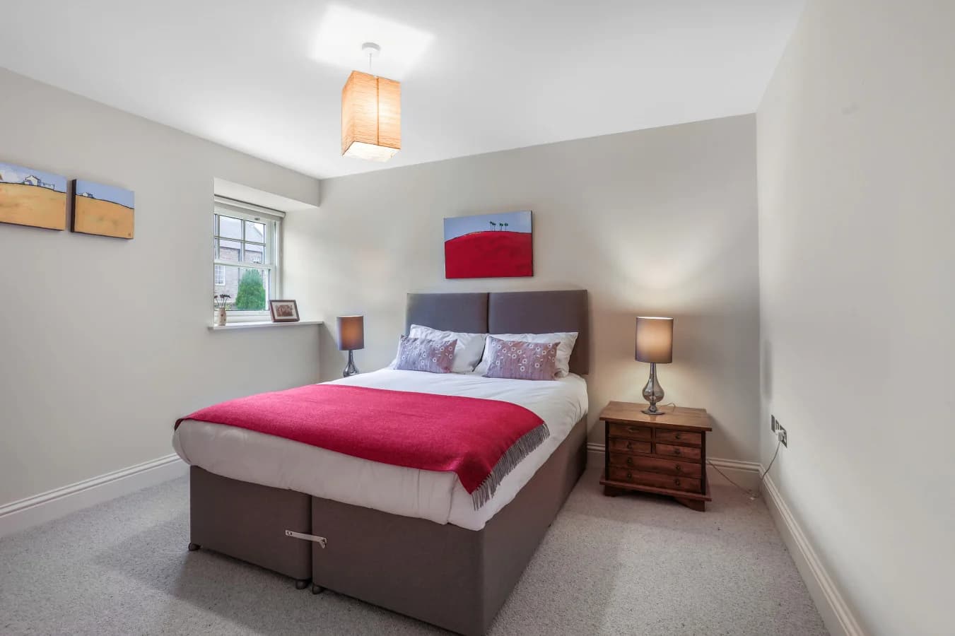 Ground-floor king bedroom with bedside tables and storage