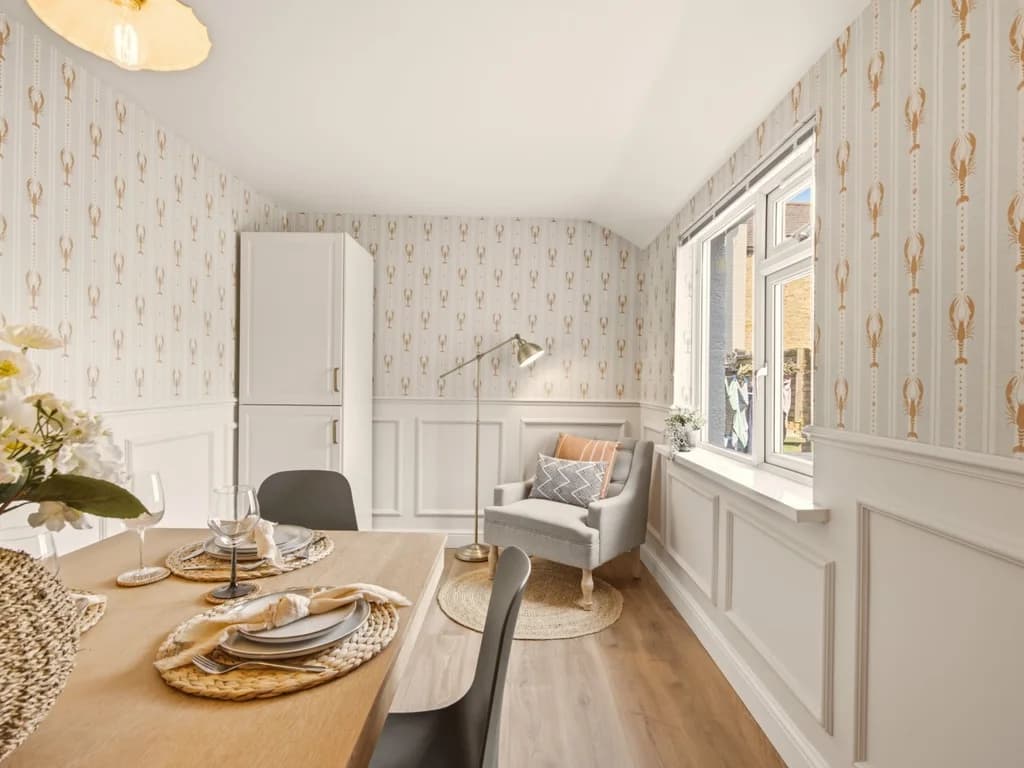 Dining area with window seat, feature wallpaper and natural light