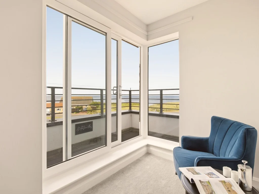 Relaxing seating area with direct access to the balcony and coastal outlook