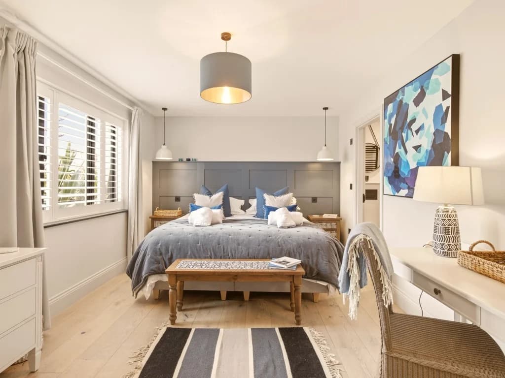 Spacious super king bedroom with feature wall, window seat and dressing table