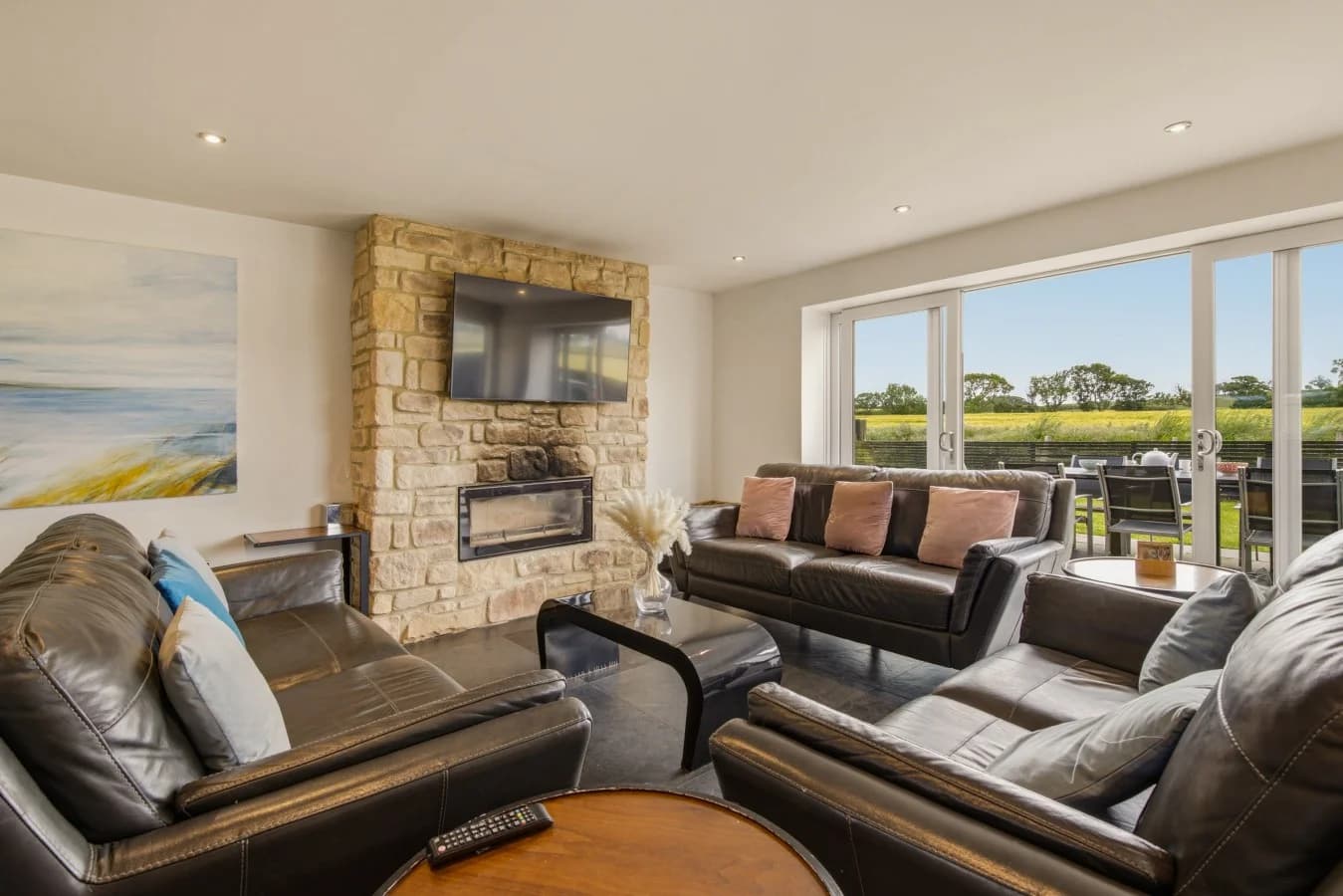 Built-in log burner beneath the Smart TV with bi-fold garden doors