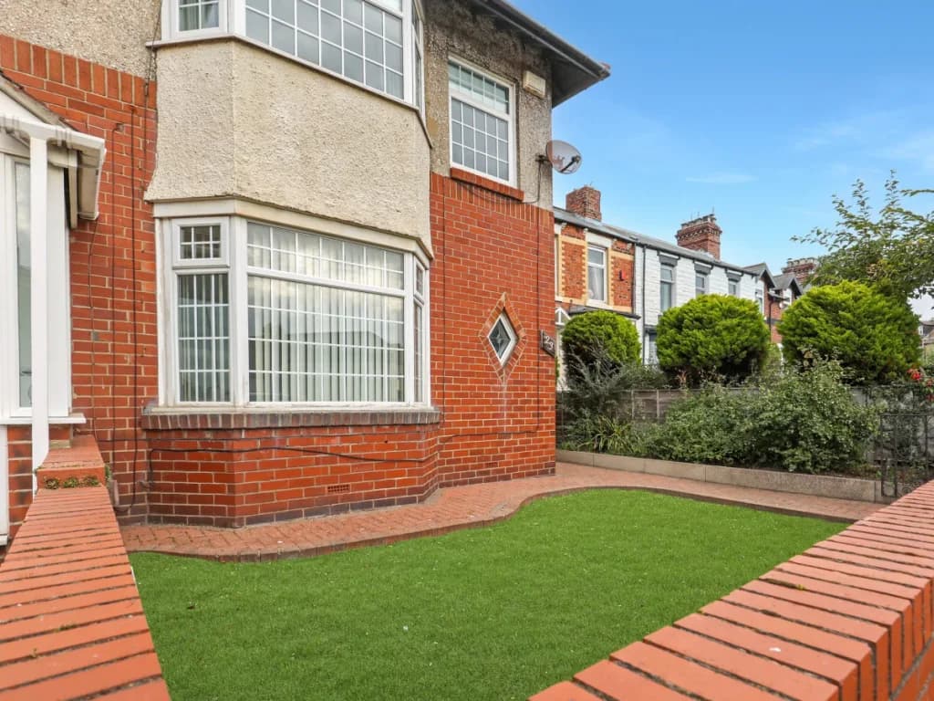 Front exterior of Sand Dancer Haven with enclosed garden and bay window
