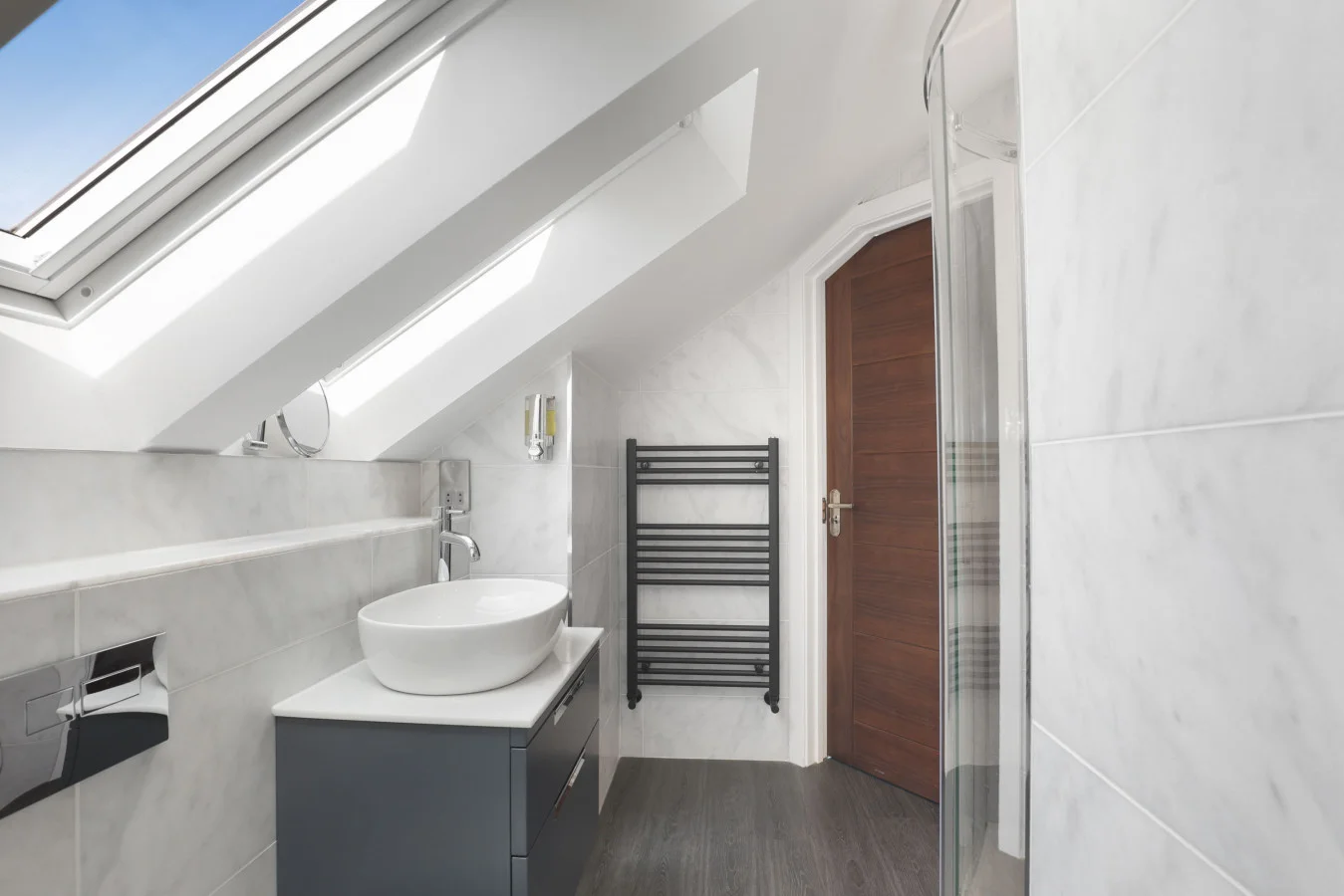 En-suite shower room with heated towel rail and vanity unit