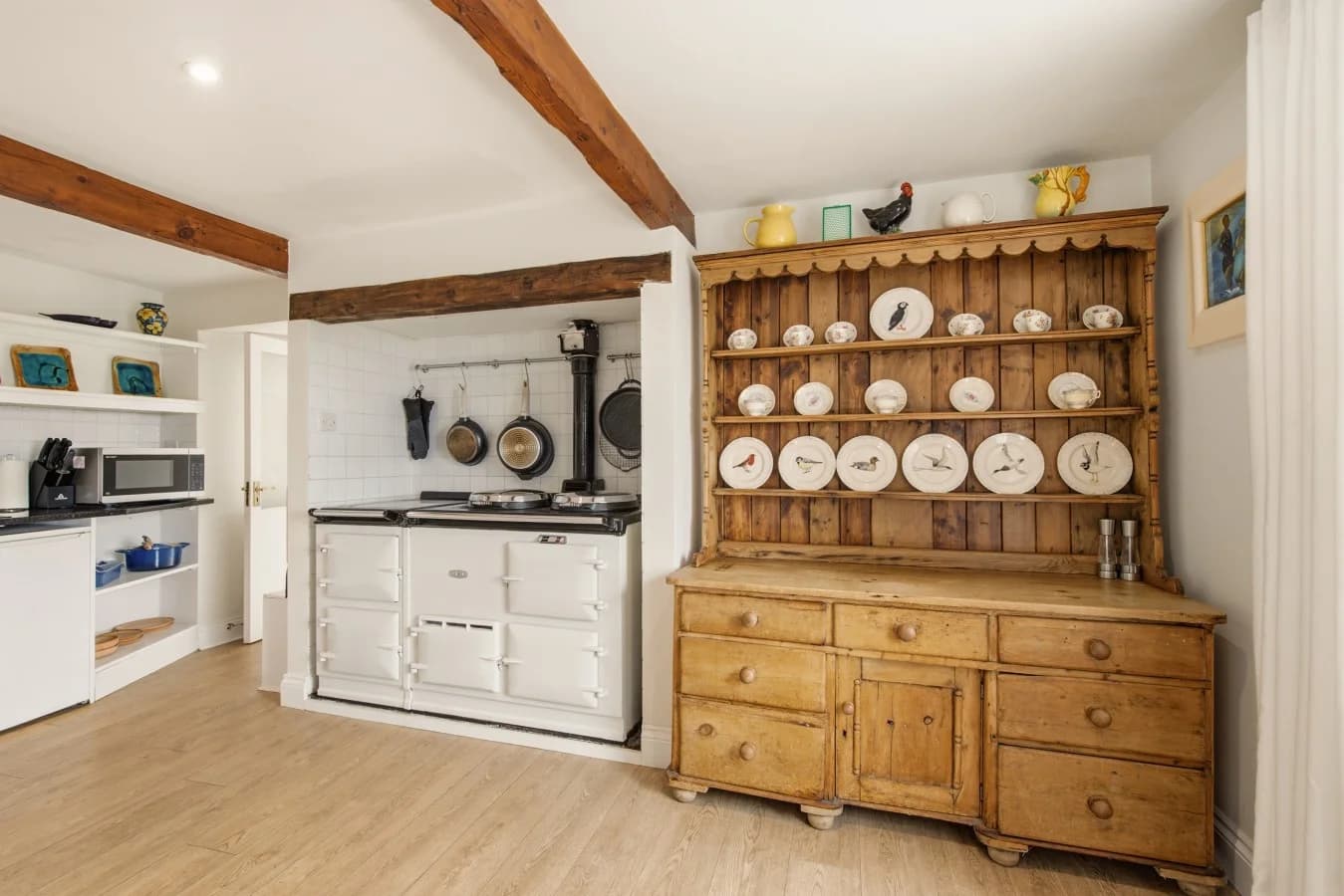 Kitchen with AGA, dresser and oak flooring
