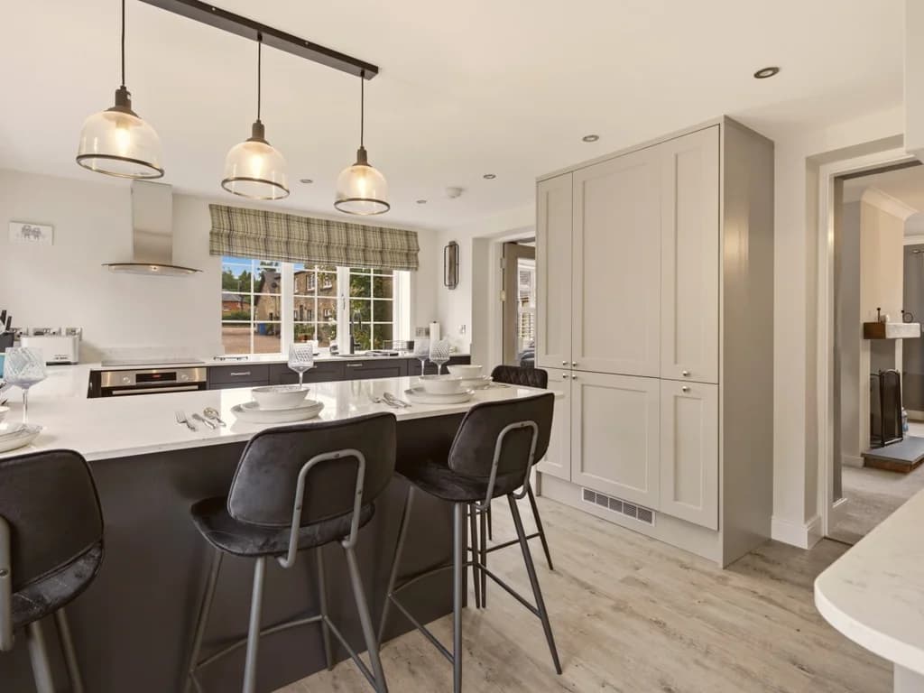 Spacious kitchen island with breakfast seating and contemporary pendant lighting