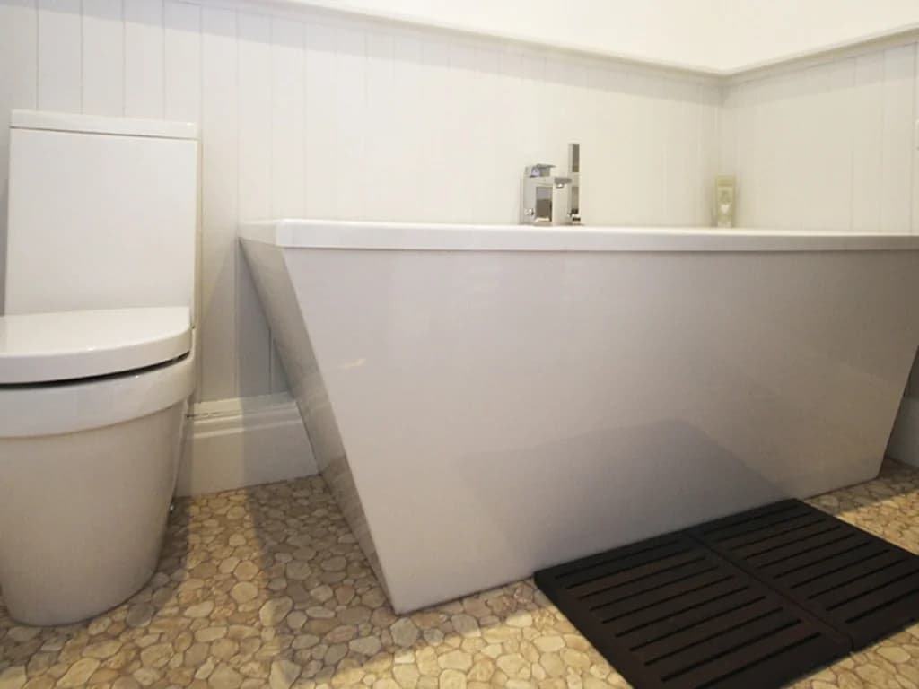 Stylish family bathroom with modern bath and contemporary finishes.