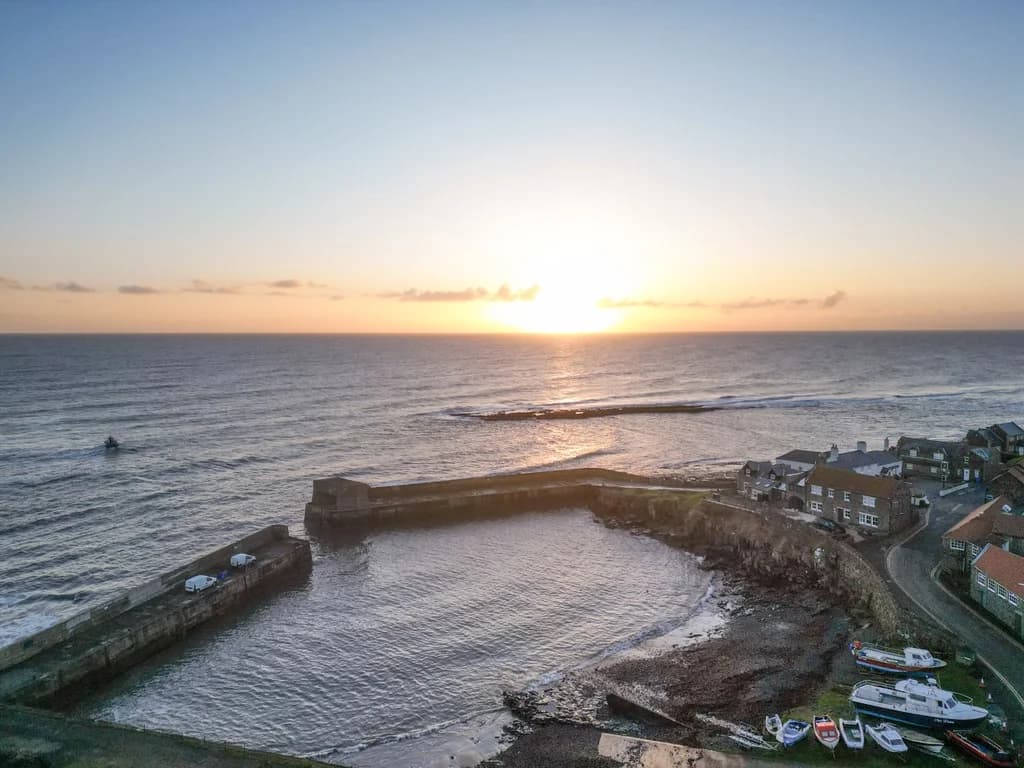 Spectacular sunset over Craster Harbour and the North Sea