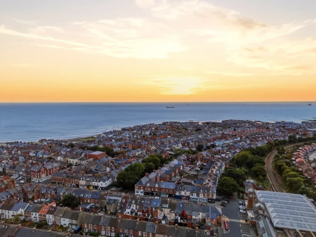 Aerial sunset view across Whitley Bay rooftops towards the coastline