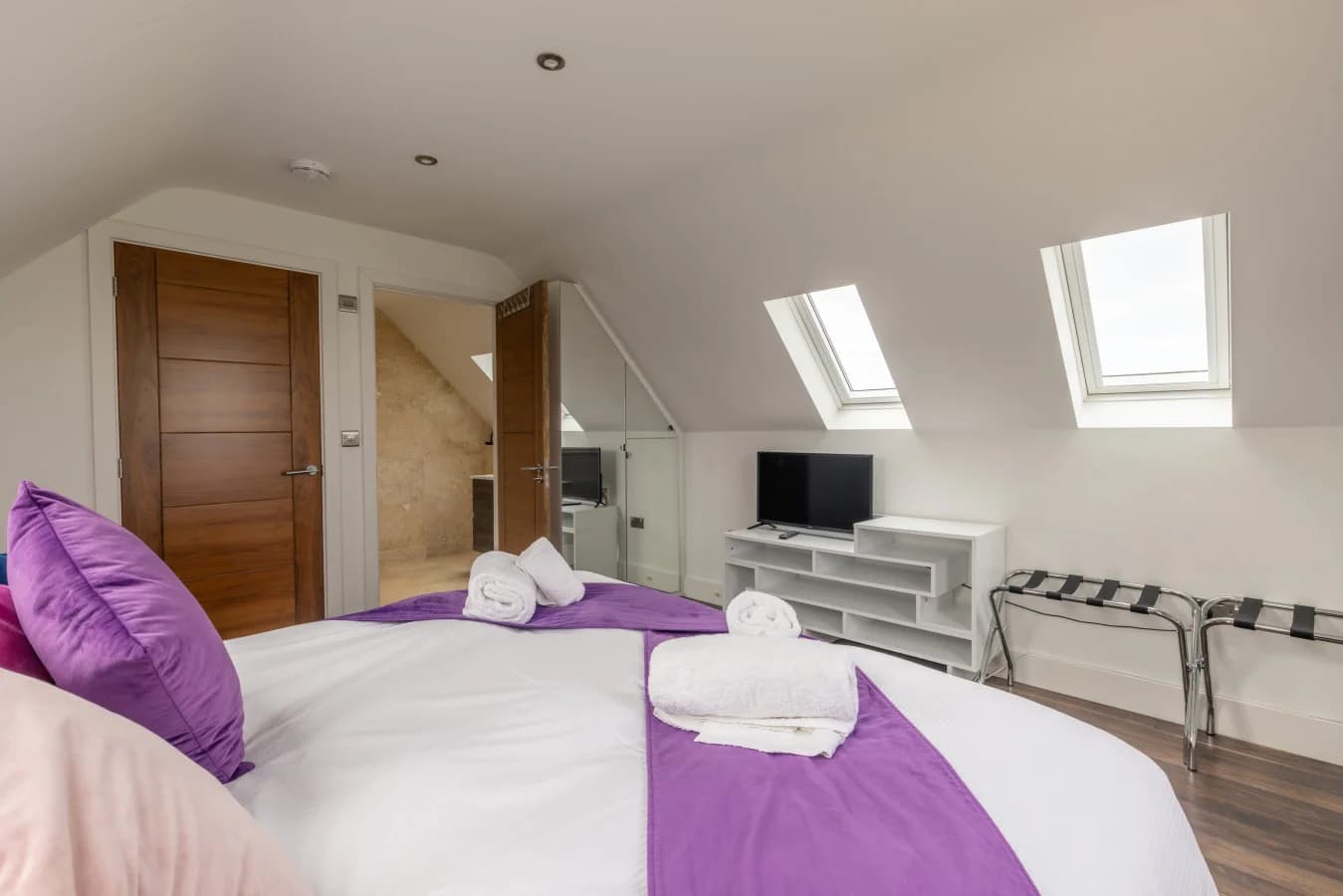 Bright bedroom with vaulted ceiling and ensuite access