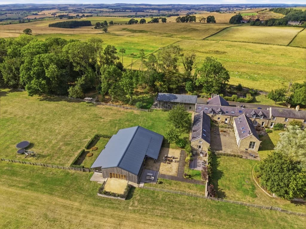 Roses Bower grounds and buildings surrounded by open fields and woodland