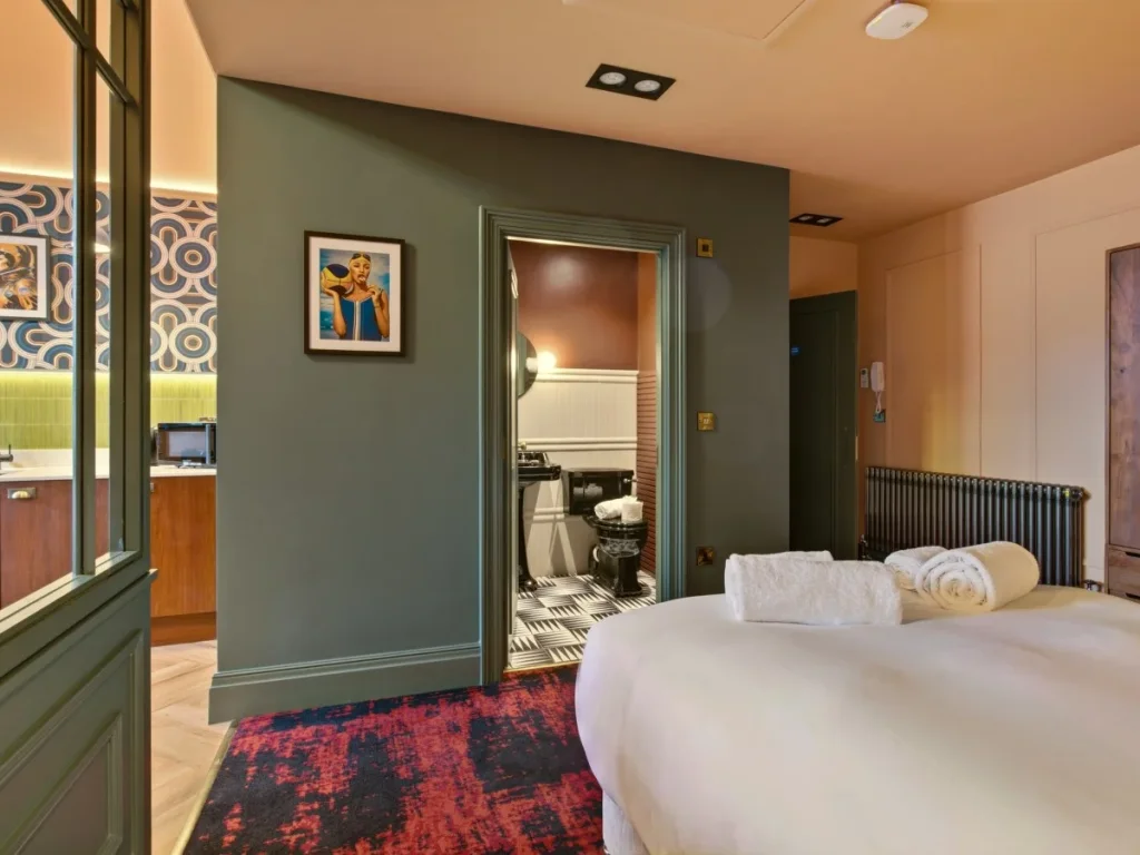 Bedroom area with decorative screen and direct access to the shower room.