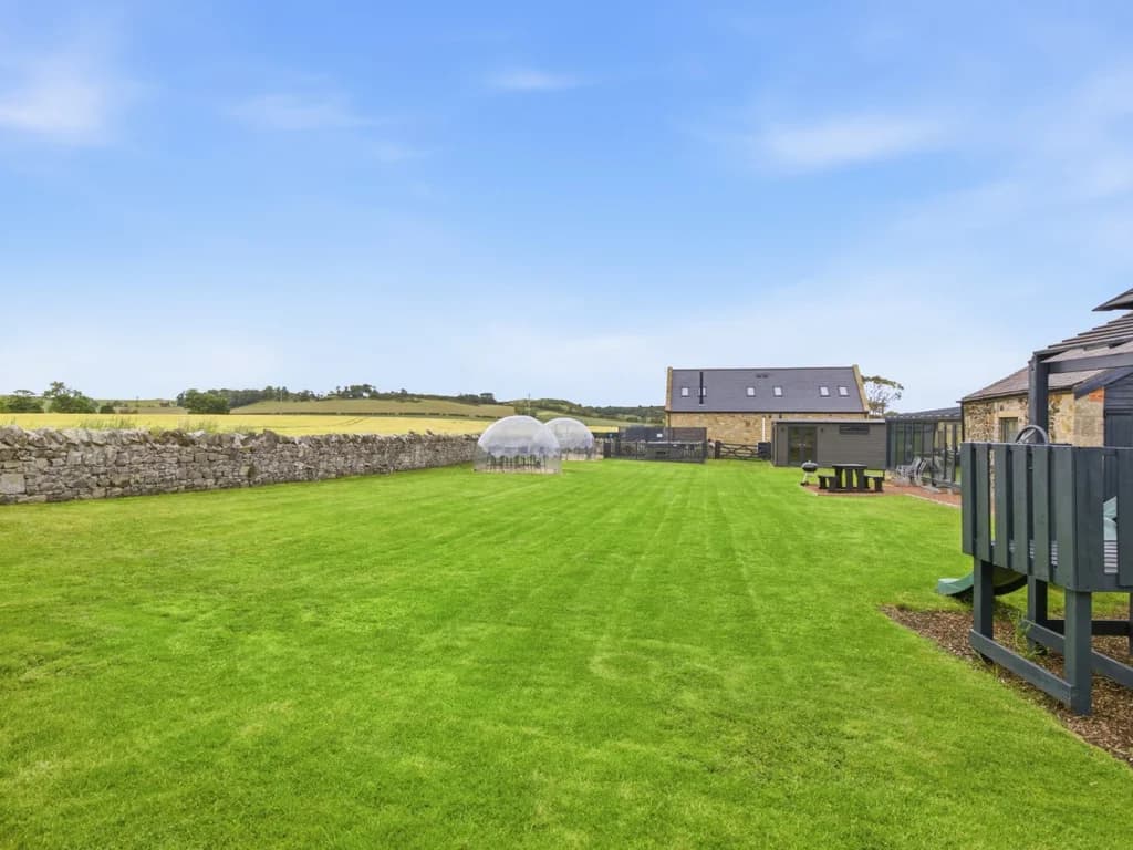 Shared paddock with open lawn and picnic benches
