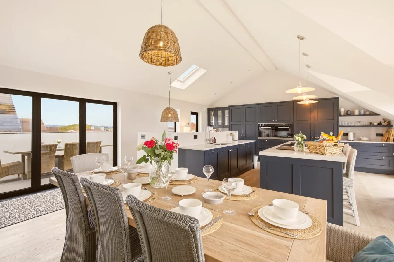 Spacious open-plan kitchen and dining area with island and vaulted ceilings