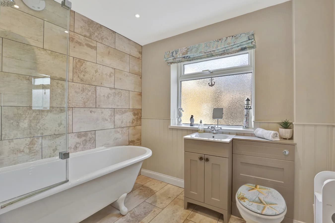 Family bathroom with freestanding bath and stone-effect feature wall