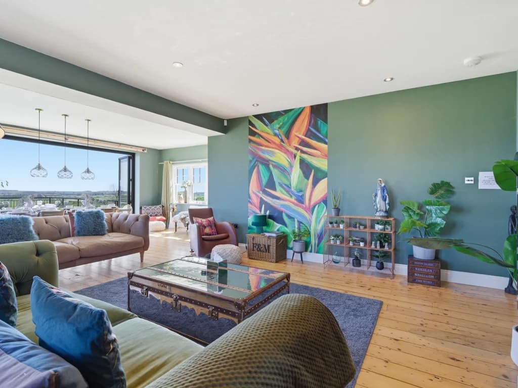 Sociable lounge with vintage-trunk coffee table and far-reaching country views.