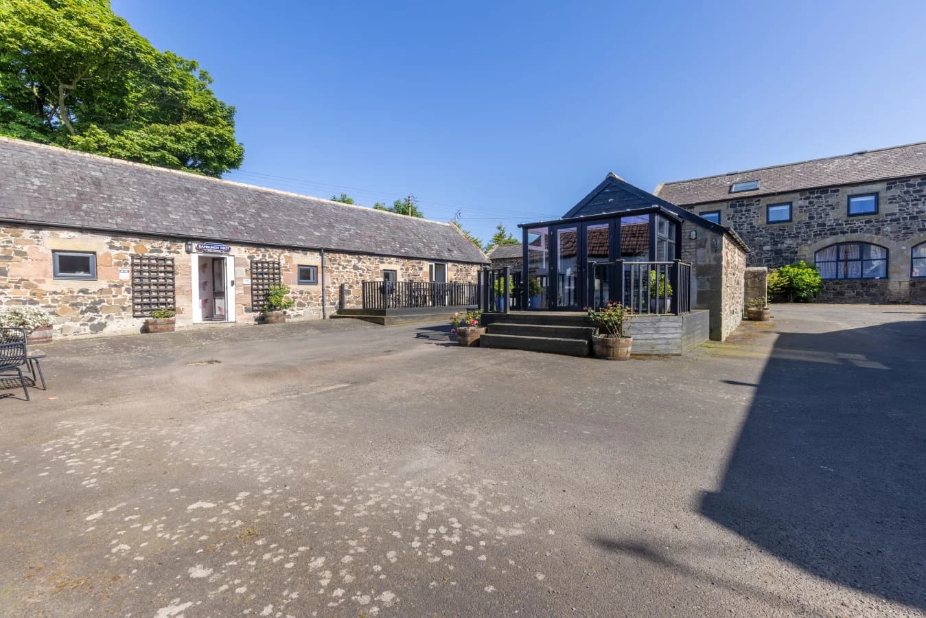 Stone courtyard with glazed communal gathering space