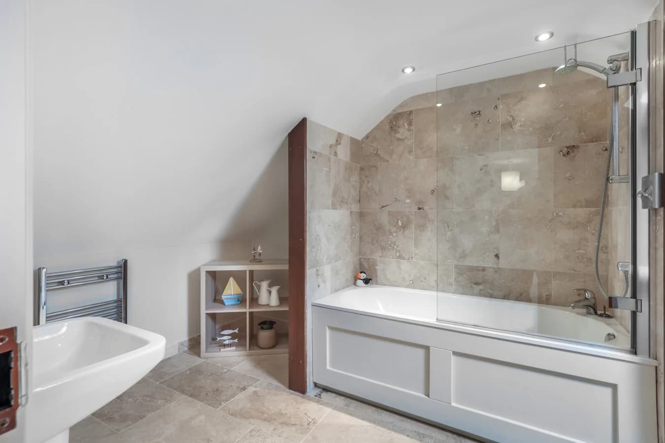 Luxury en-suite bathroom with stone tiles and freestanding bath