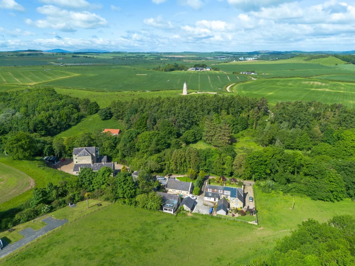 Aerial view of the cottage complex and surrounding woodland