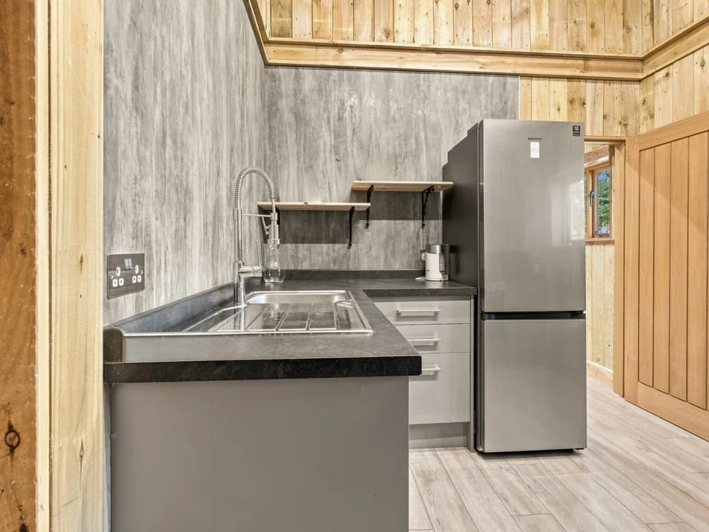 Practical kitchen with sink, fridge freezer and generous worktop space