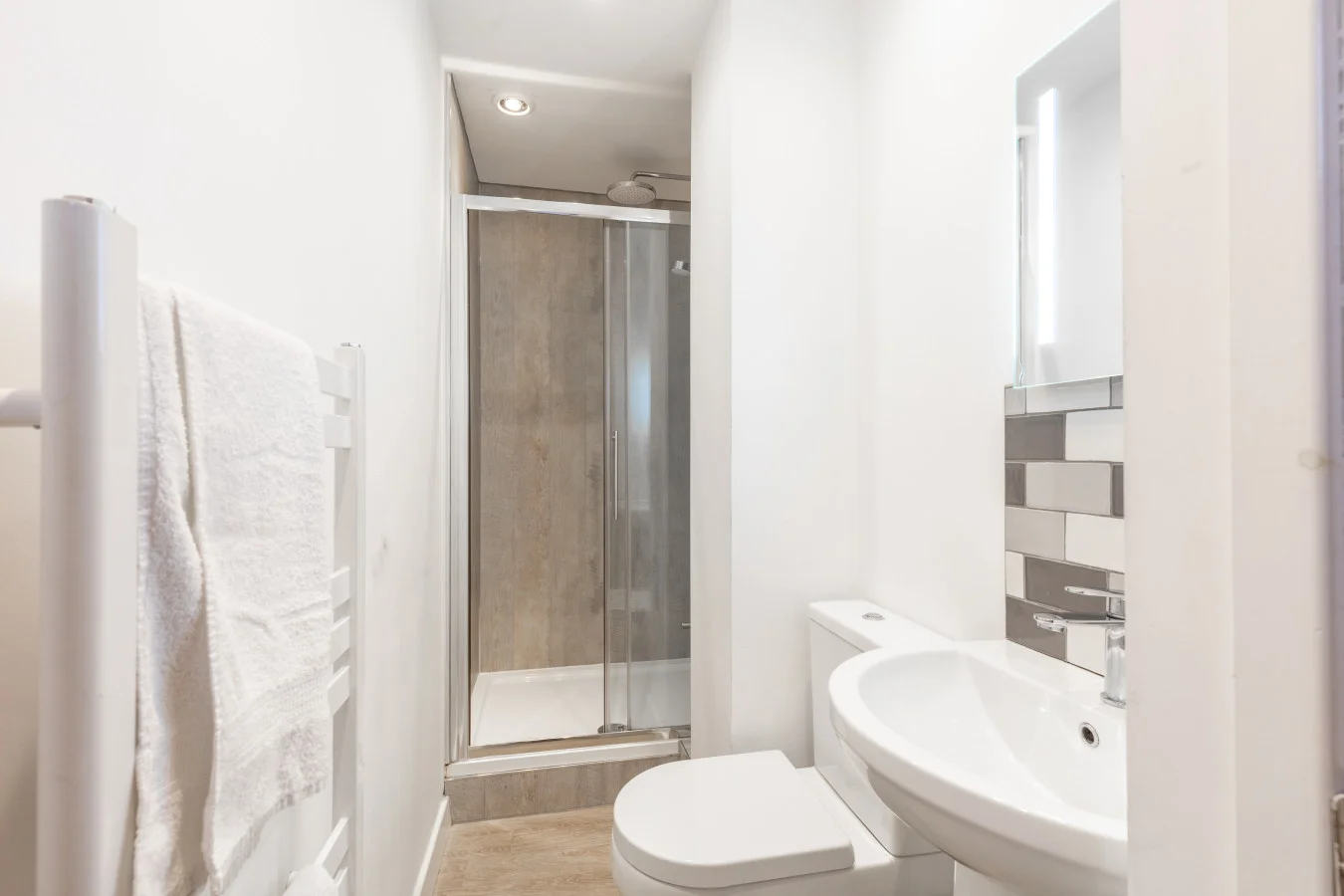 Modern shower room with walk-in enclosure and heated towel rail