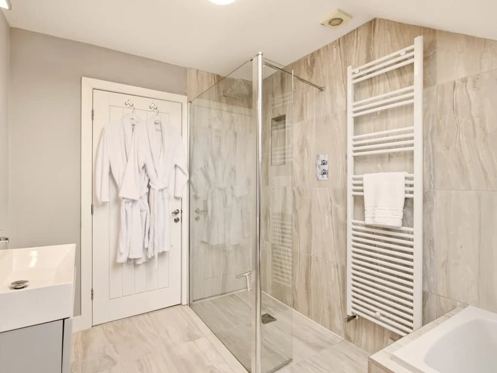 Family bathroom with walk-in shower, heated towel rail and bath