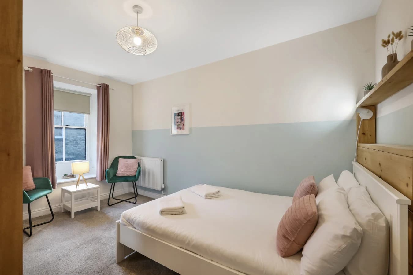 Serene double bedroom with blush accents and soft sage panelled walls