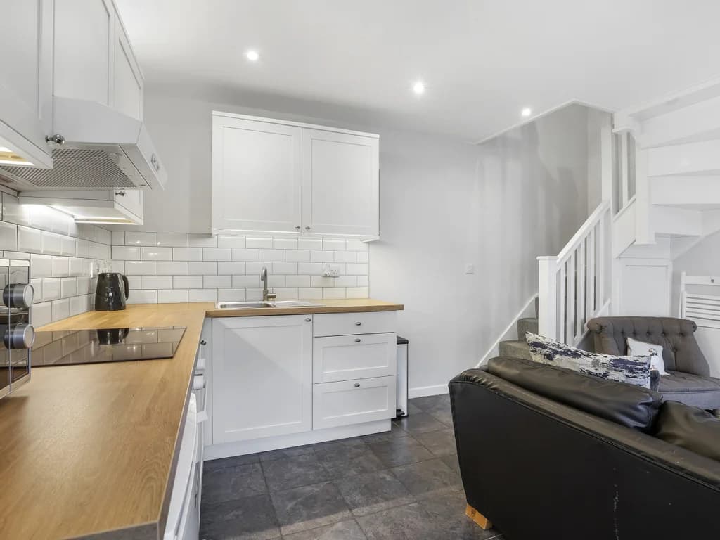 Compact kitchen with integrated appliances and coastal styling