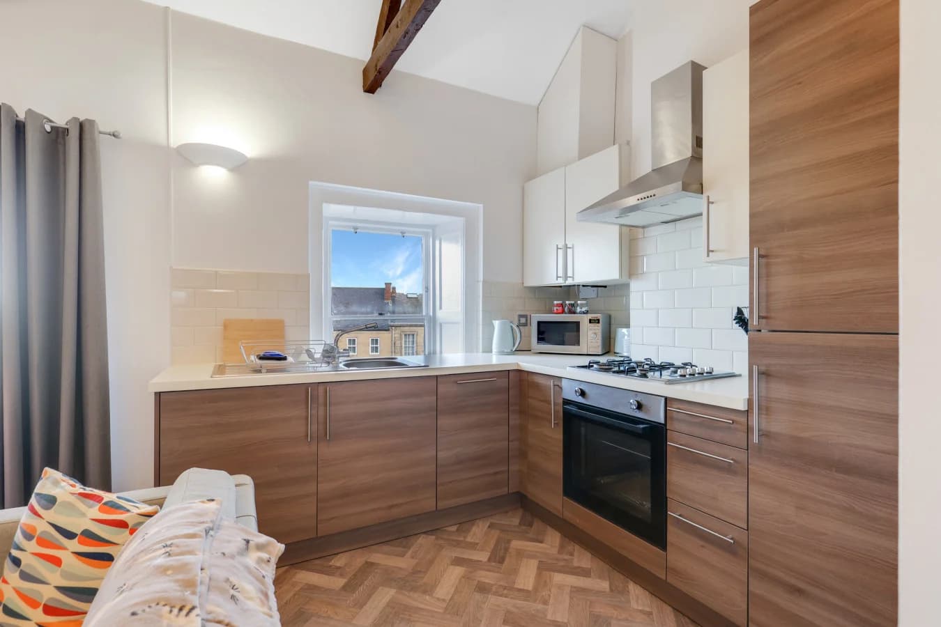 Modern kitchen with walnut-effect cabinetry and integrated appliances