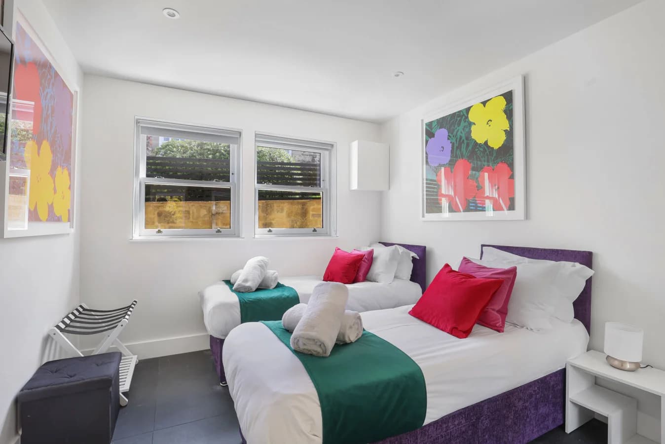 Twin bedroom with dual-aspect windows and upholstered bed bases