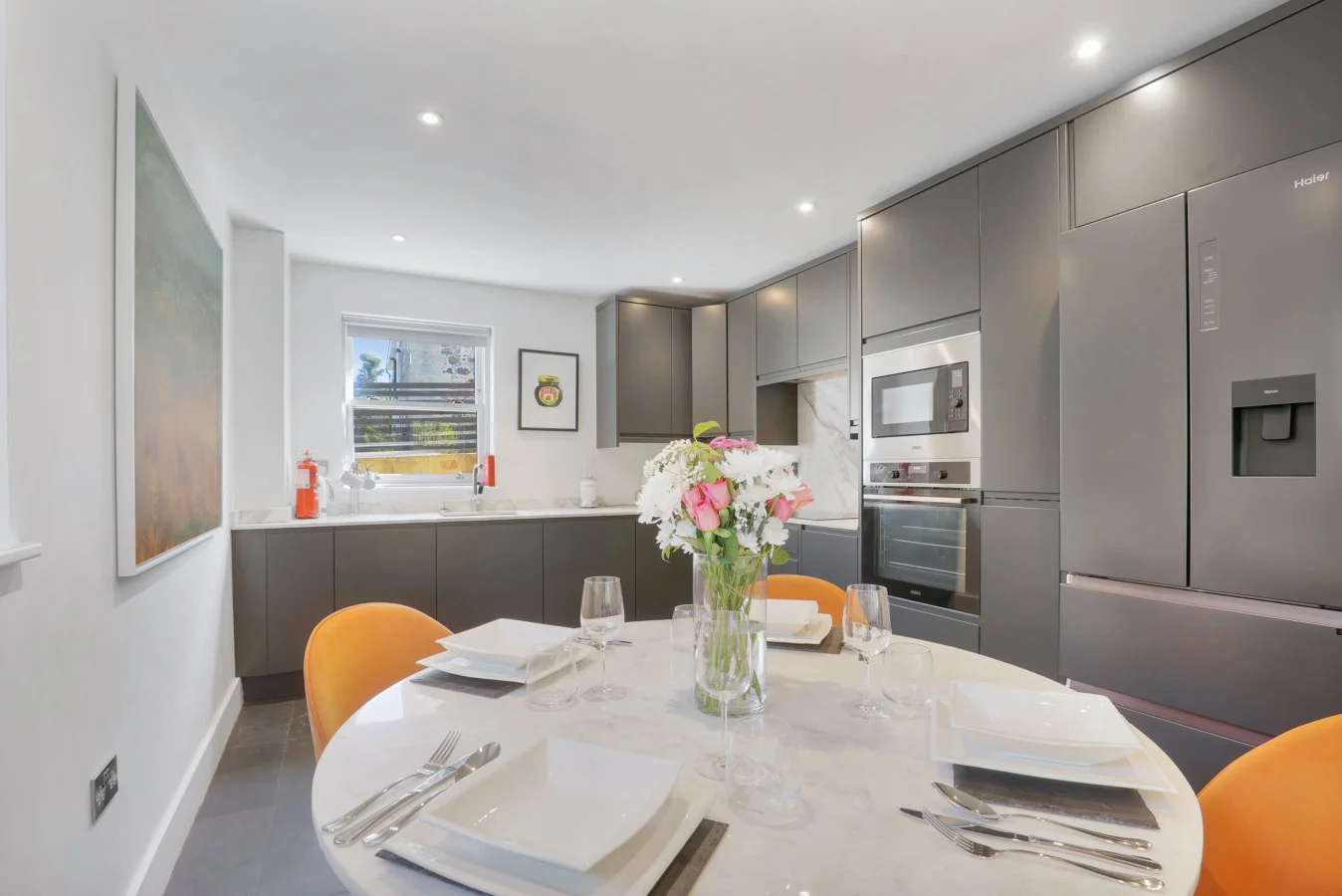 Contemporary kitchen with quartz dining table and integrated appliances