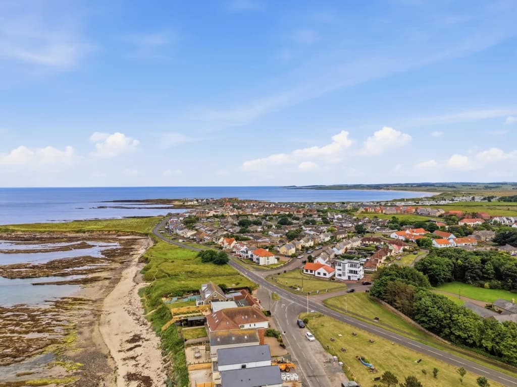 Stunning aerial view of Beadnell village, beach and Northumberland coastline