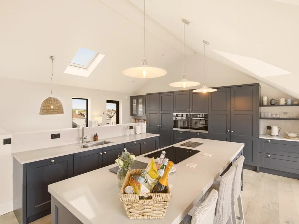 Stylish kitchen with navy cabinetry, integrated appliances and open shelving