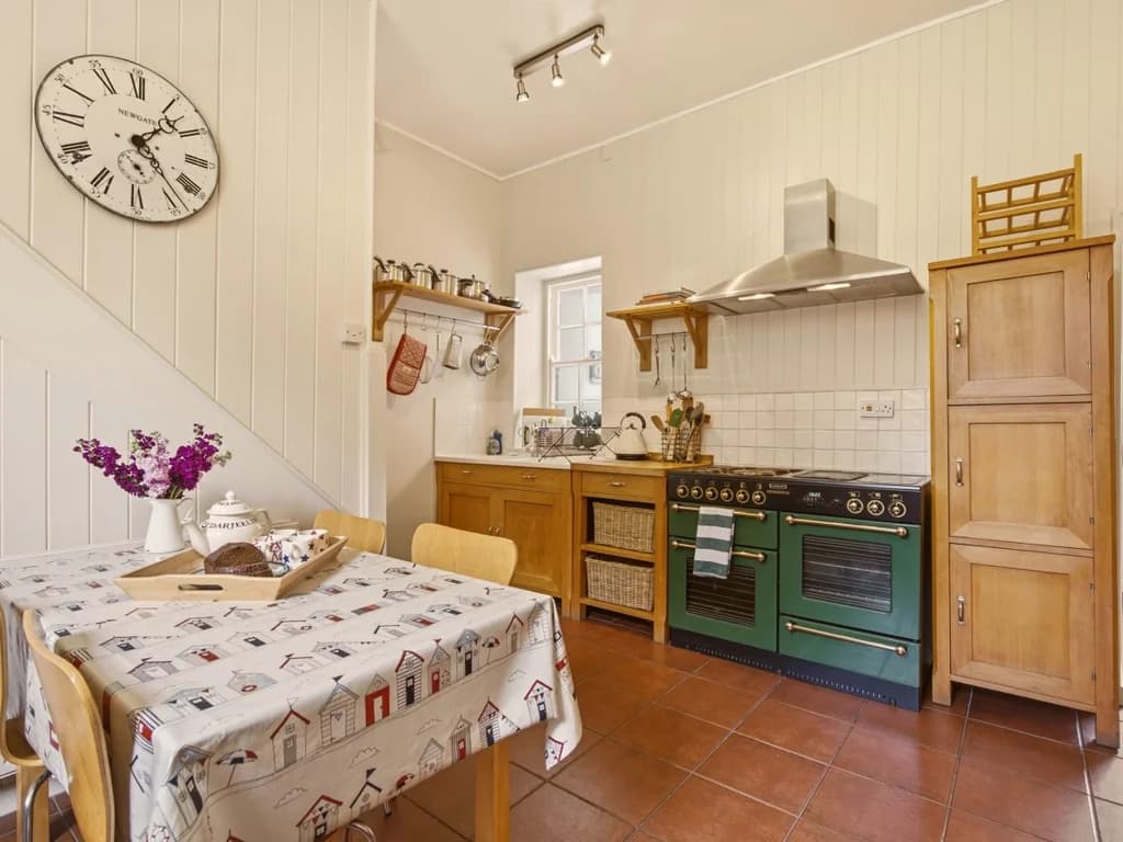 Traditional farmhouse kitchen with breakfast table and classic range cooker