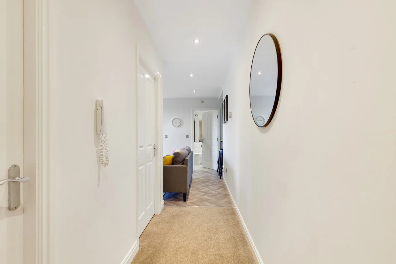 Entrance hallway leading through the apartment's bright interior spaces