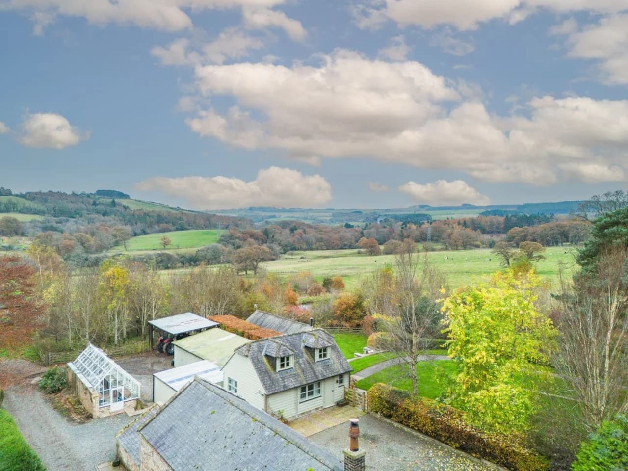 Cottage and grounds set against far-reaching valley views
