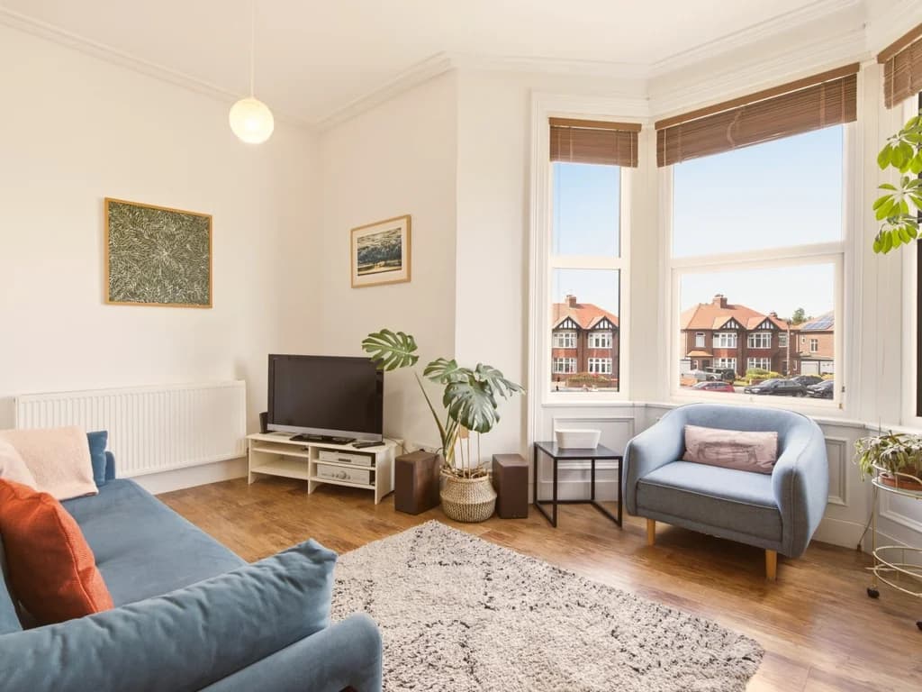 Bay window seating area with TV and views towards the seafront.