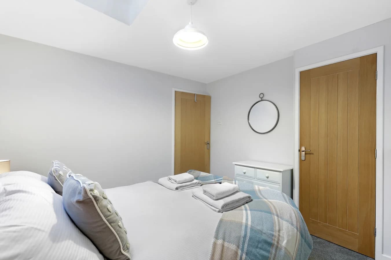 Alternative view of the bedroom with warm timber doors and skylight
