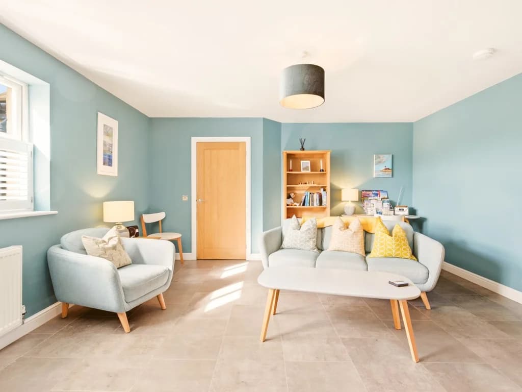 Bright lounge with coordinated seating, shelving and plenty of natural light