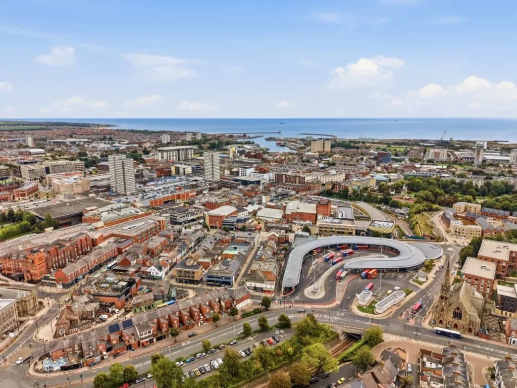 Aerial view across Sunderland city centre towards the coastline and sea.