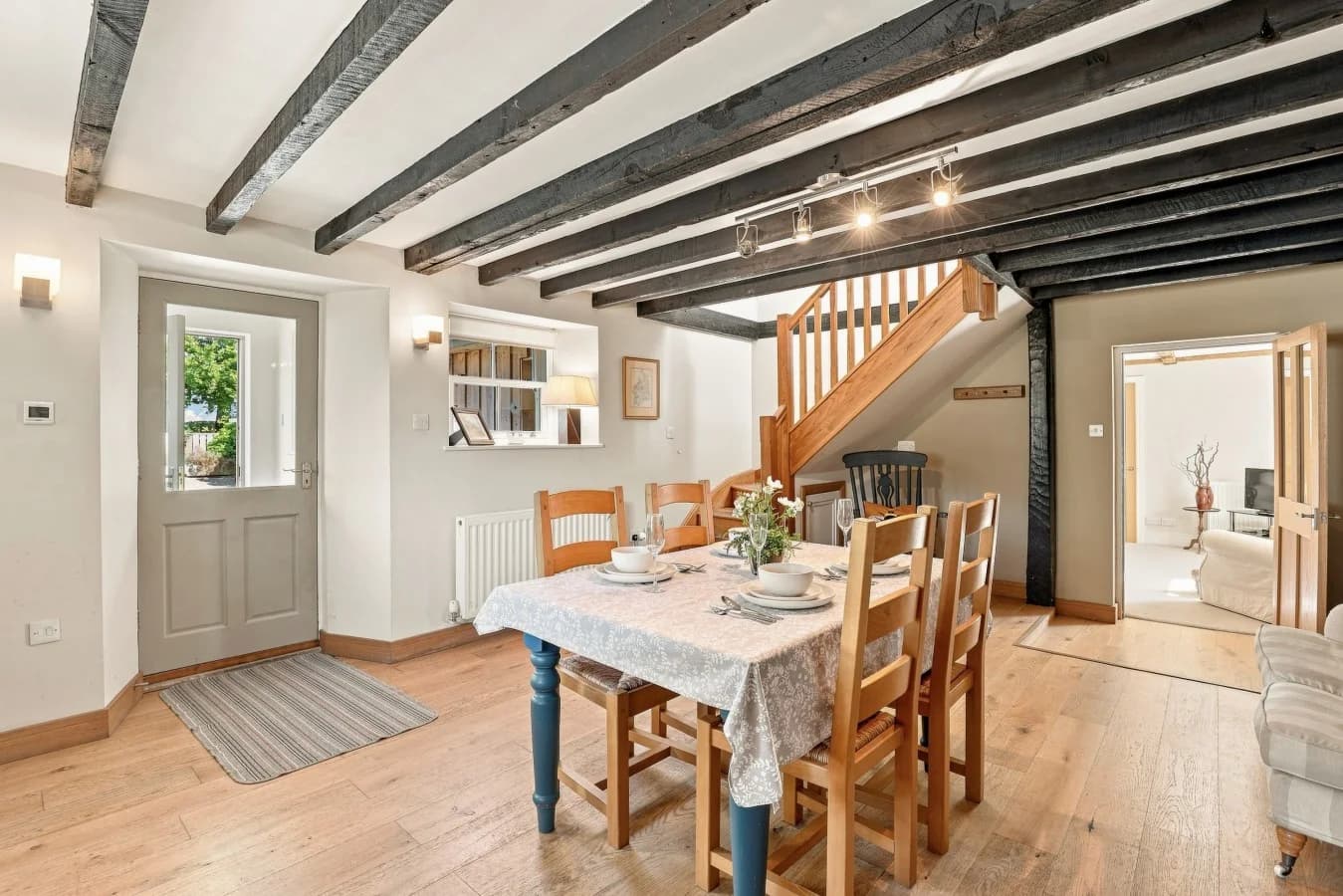 Dining space with exposed ceiling beams and cottage-style details