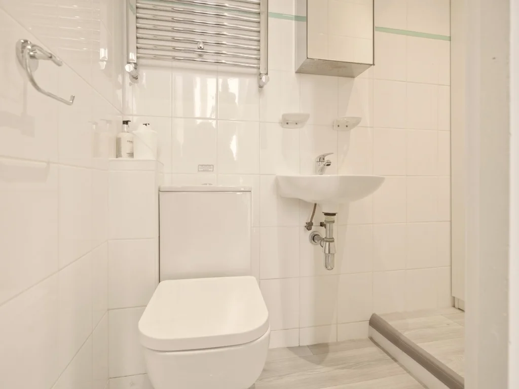 Bright en-suite bathroom with shower, heated towel rail and modern fittings